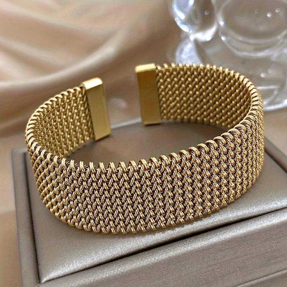 Stylish woven stainless steel bracelet with a golden touch, versatile accessory in trendy golden tone.