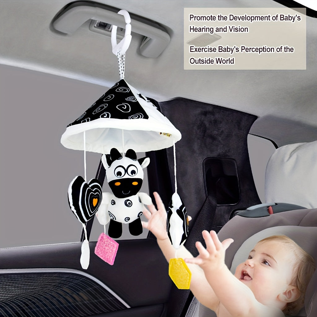 Baby toy car in black and white hanging from the baby trolley, with an umbrella wind chime for early education. The crib bell and stroller hanging umbrella bed bell pendant features black and white animal wind chimes. Additionally, there is a bed hanging