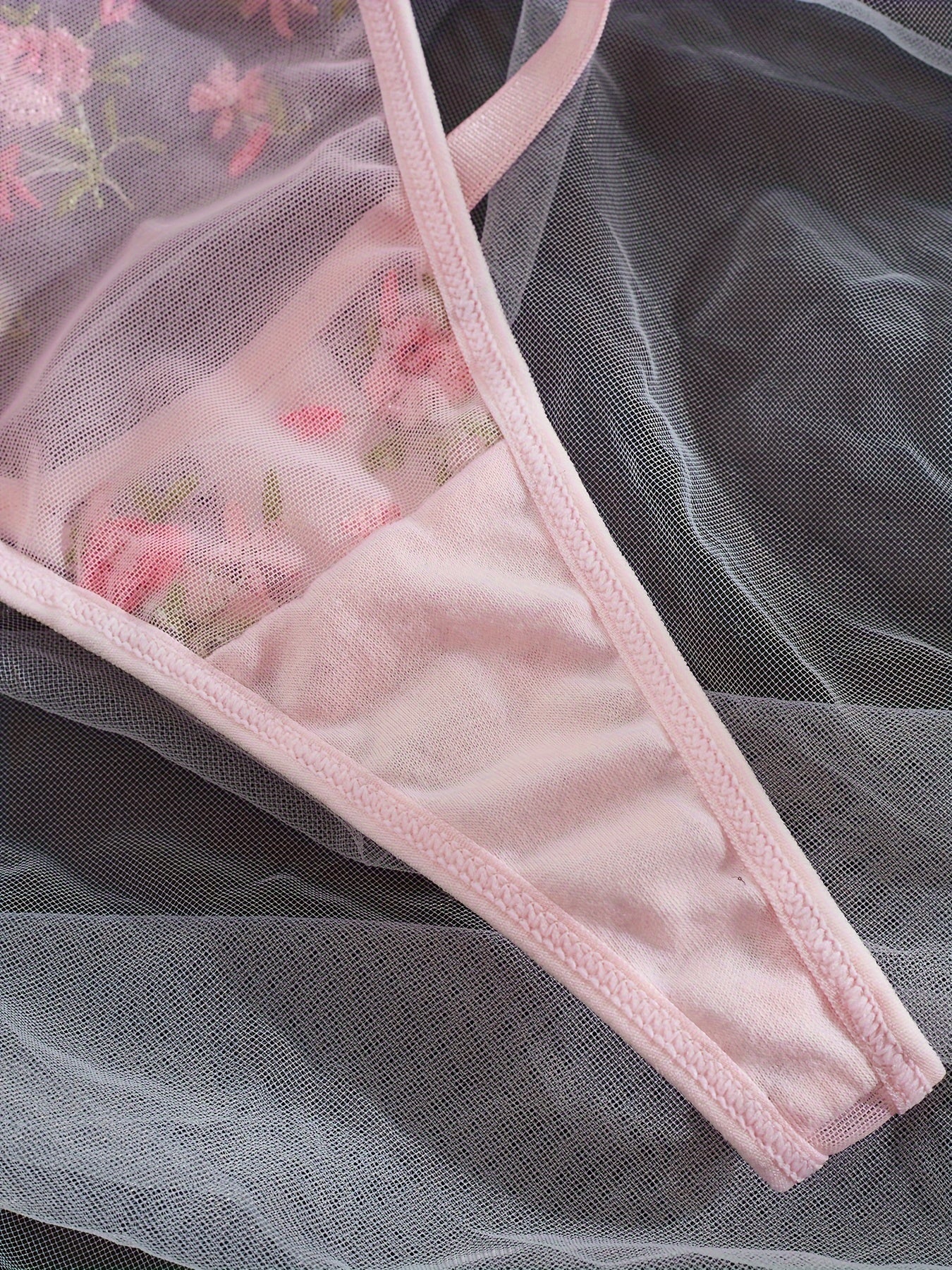 Chic French-inspired lingerie set in pink with floral embroidery and butterfly lace, featuring a sheer mesh bra and thong combo, medium support, hand wash only.