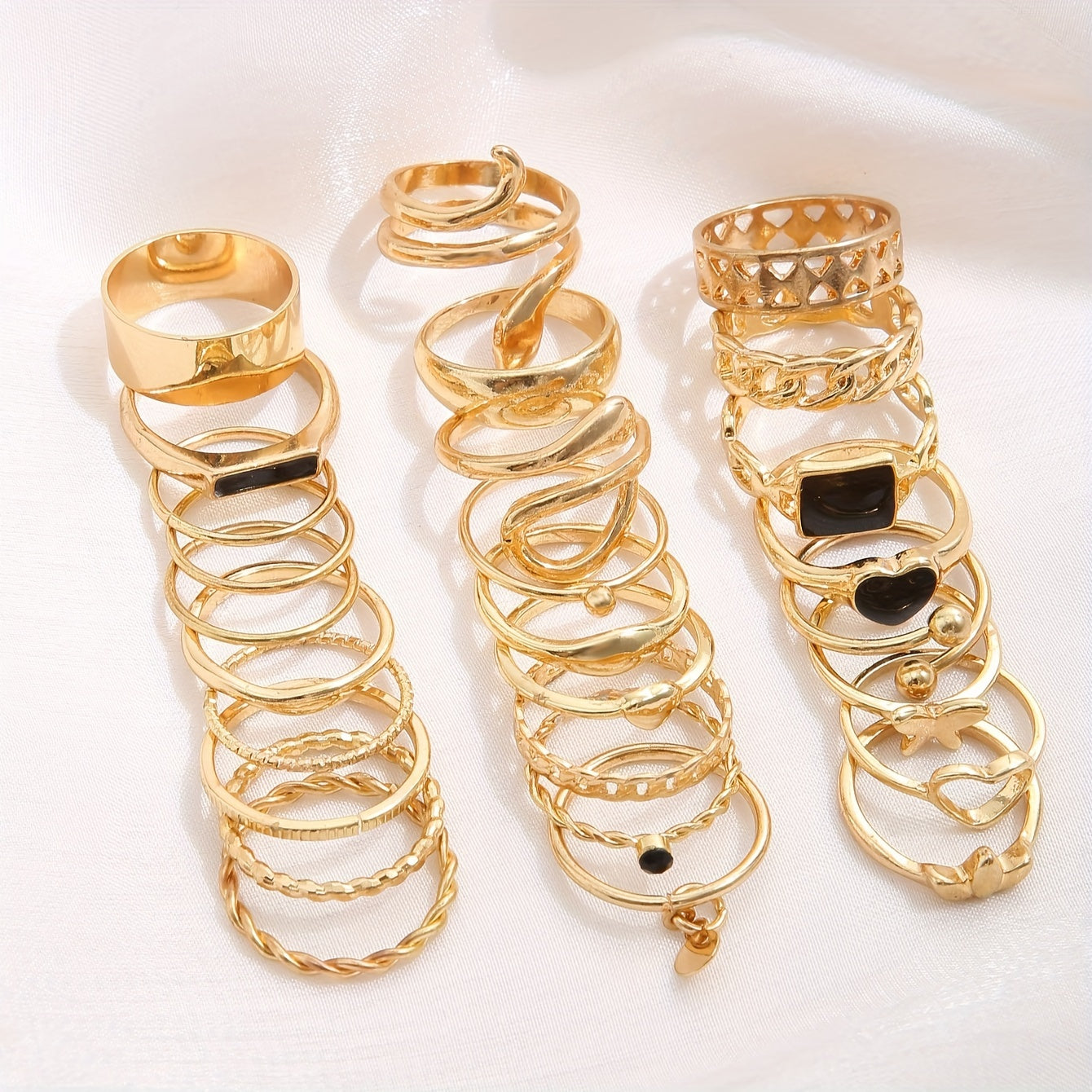 Vintage stackable rings set with 27 pieces made of zinc alloy. Features various designs including hearts, butterflies, snakes, drops, geometric shapes, discs, hollow chains, and wide faces.