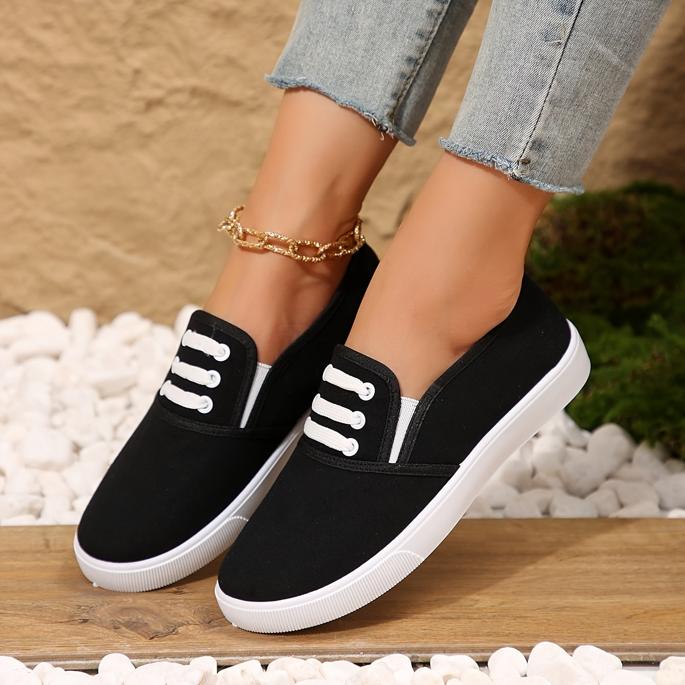 Lightweight white slip-on canvas sneakers for women with a soft sole and minimalist design.