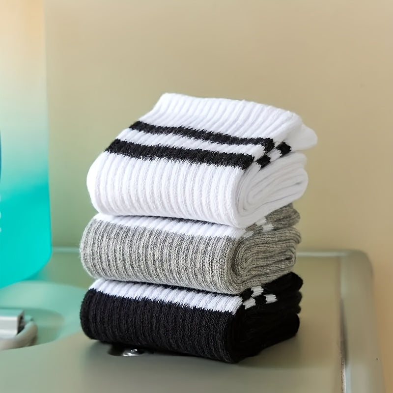 3 pairs of knee-length striped socks for women in black, white, and grey. Made of breathable polyester knit fabric with a casual sport style. Hand wash or dry clean.