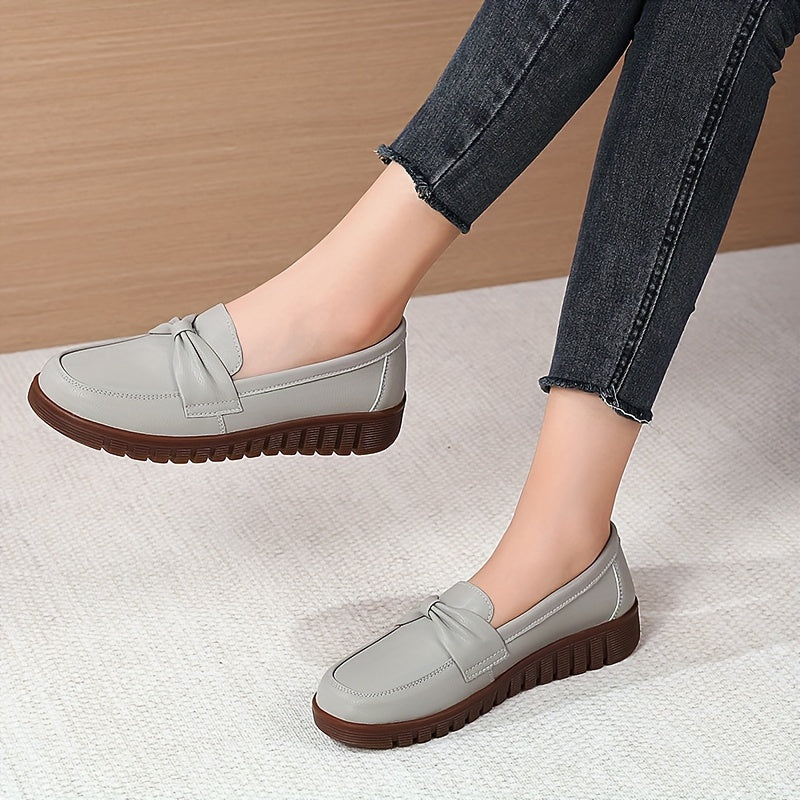 Women's comfortable penny loafers with bow embellishment, non-slip sole, round toe, all-season footwear, man-made materials, TPR sole.