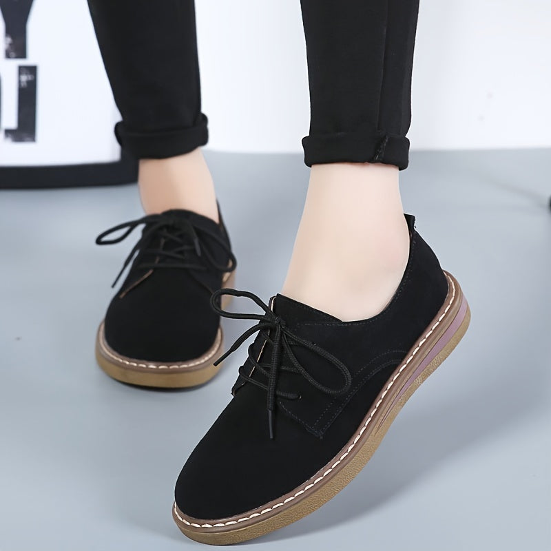 Women's flat, lace-up loafers in solid color, perfect for back to school with a comfortable preppy style.