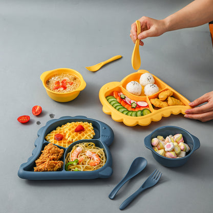 Children's dinnerware set shaped like dinosaurs - made of BPA-free plastic includes plate, bowl, fork, and spoon.