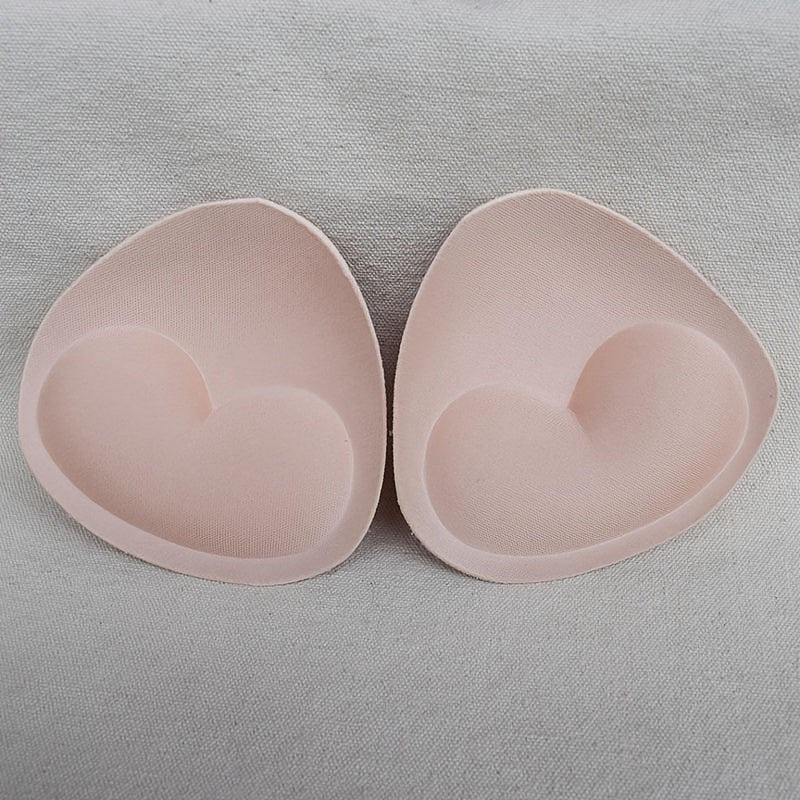 2 pairs of heart-shaped sponge bra inserts, washable and removable cup enhancers for bikinis, tops, and bras. Made from soft and breathable PU material for comfortable fit.