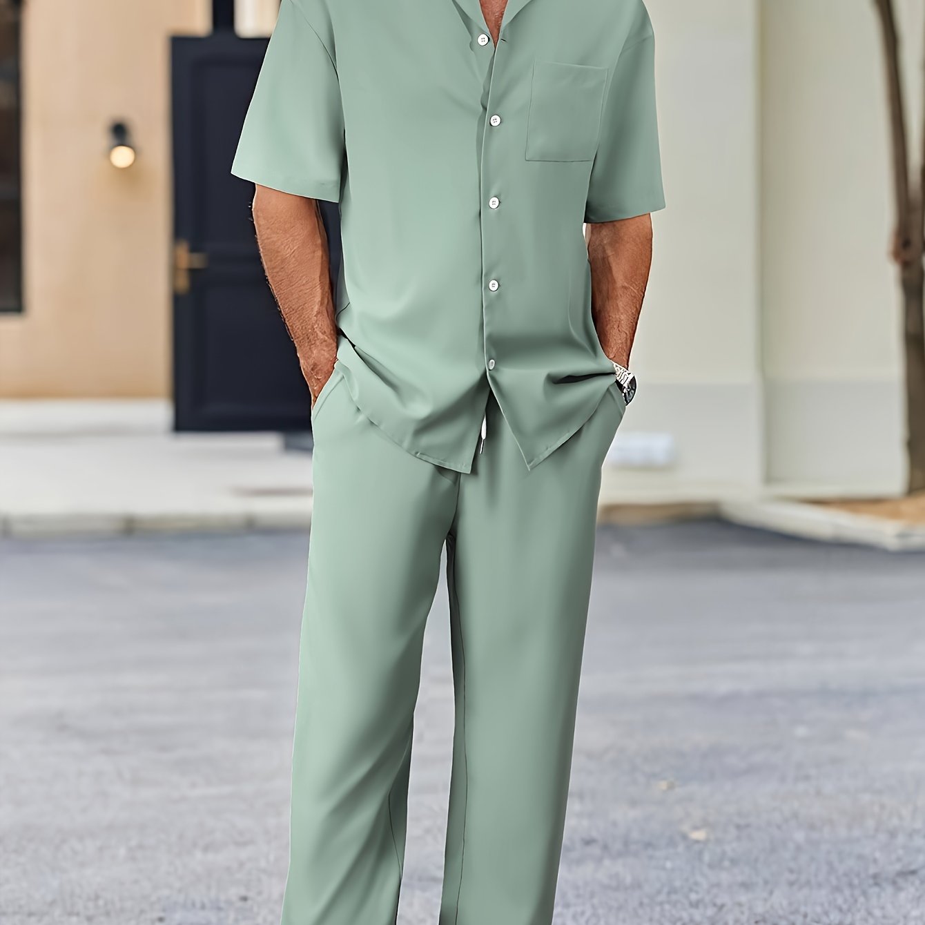 Men's casual suit-inspired set includes short sleeve shirt and loose straight pants made of polyester, machine washable.