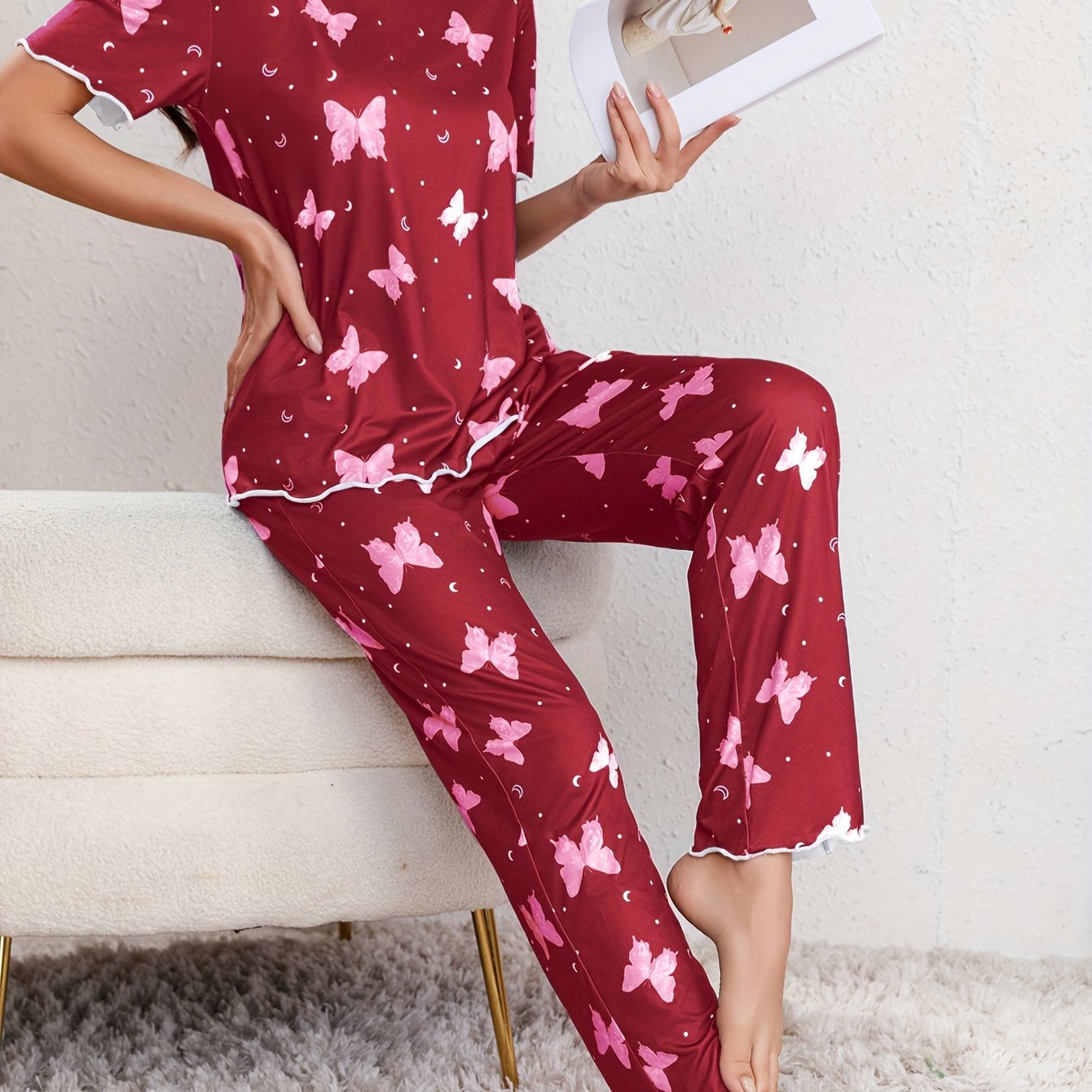 Butterfly print lounge set for women with lettuce trim, short sleeve top, and pants.