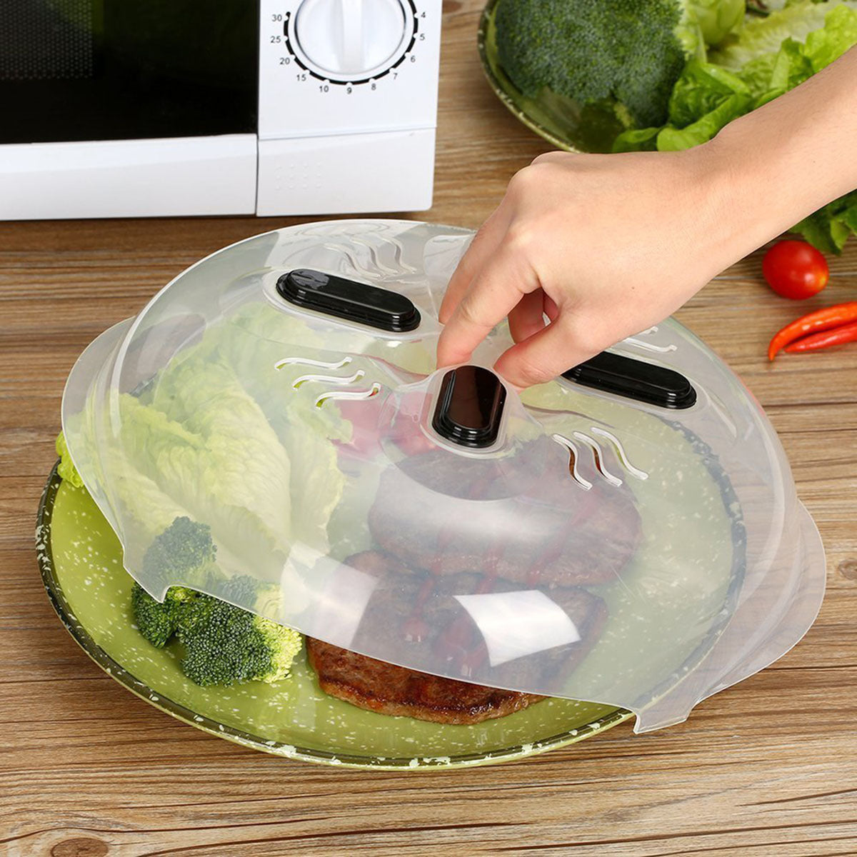 Protect your microwave with this clear splatter cover featuring magnetic venting. Made from heat resistant non-food safe plastic, this lid is perfect for heating up pizza, casseroles, and bowls. An essential kitchen accessory, this microwave food cover