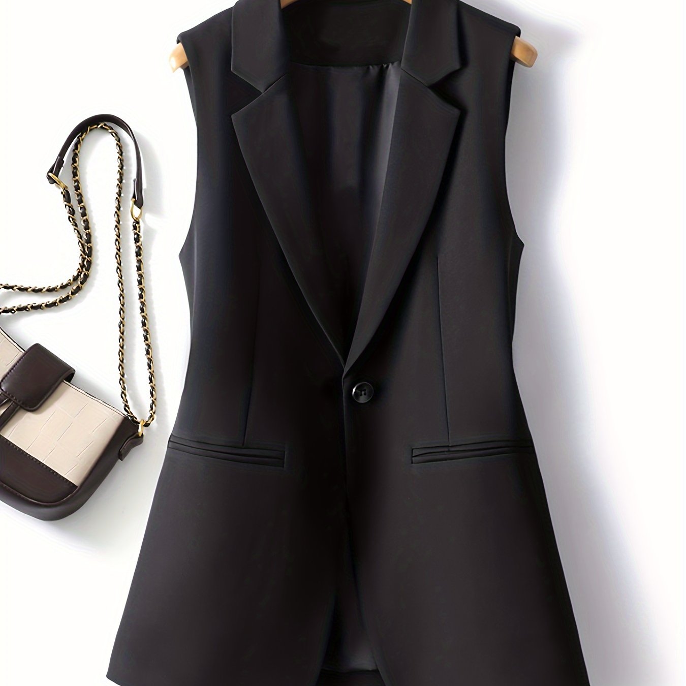 Sleek solid color button-front vest with sleeveless lapel collar for spring & fall.