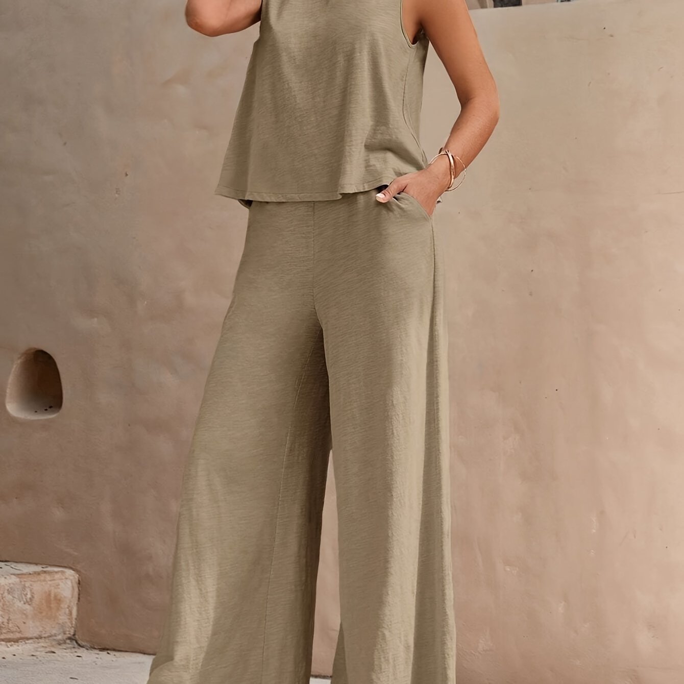 Elegant two-piece set with sleeveless tank top and wide leg loose pants for women.