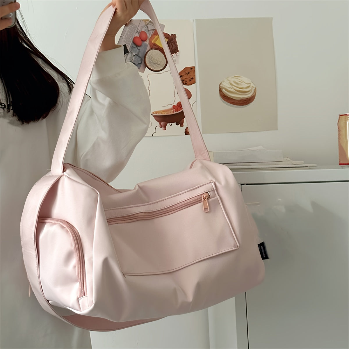 Pink duffel bag with headphone jack for gym, travel, and short trips; lightweight, stylish, and portable.