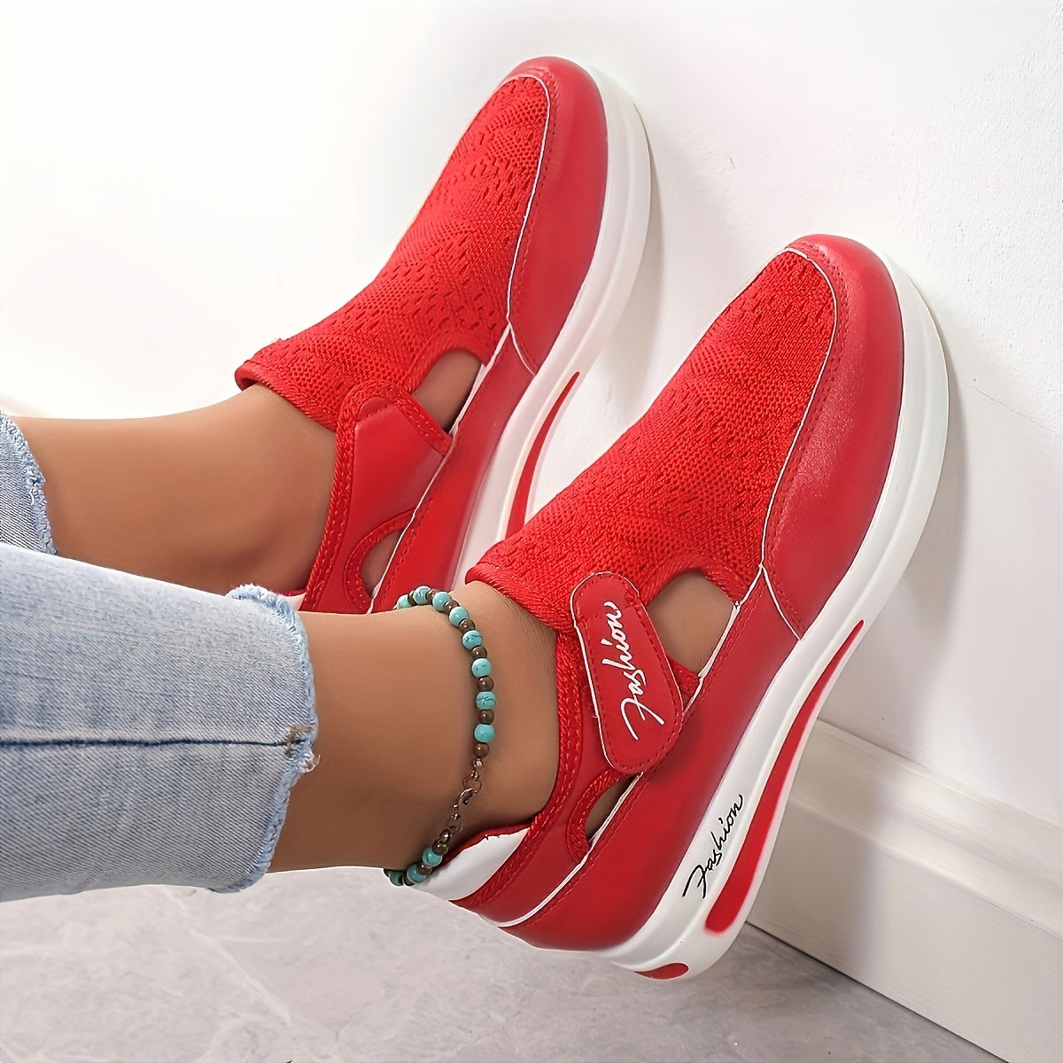 Women's fashion sneakers in red color, with breathable mesh, hook-and-loop fastener strap, and low-top design for all-season wear.