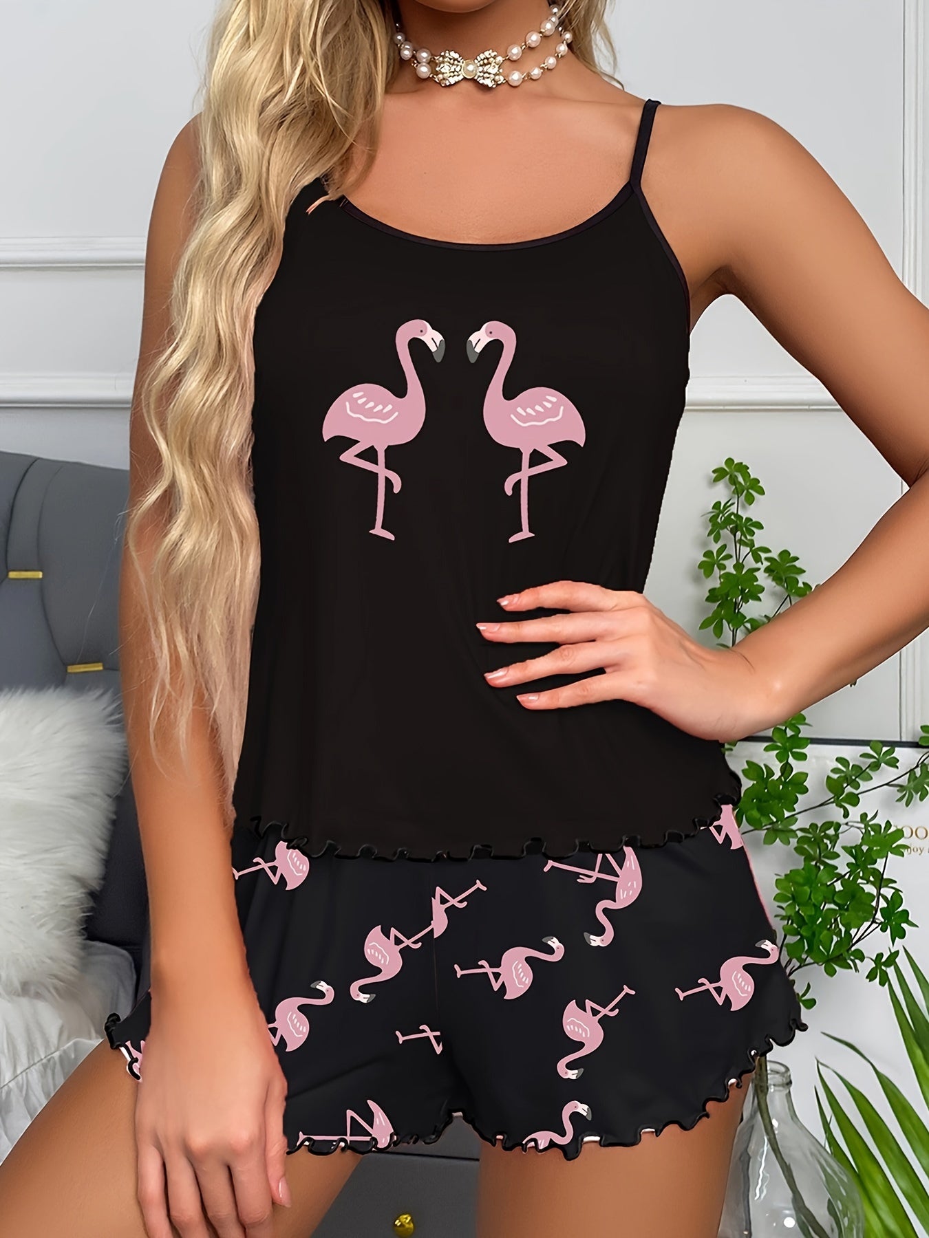 Flamingo print clothing set for women, made of polyester and spandex blend. Includes scoop neck cami top with ruffle hem shorts. Machine washable in pink.