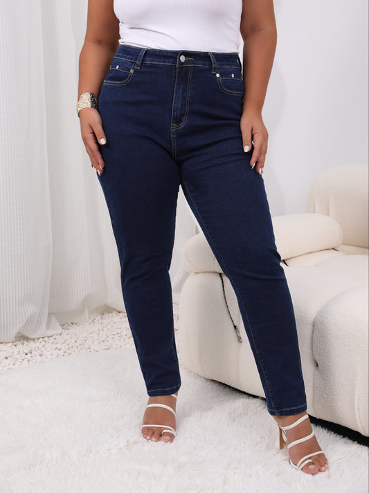 Women's plus size high-rise jeans with solid color and button fly, offering a comfortable stretch fit.