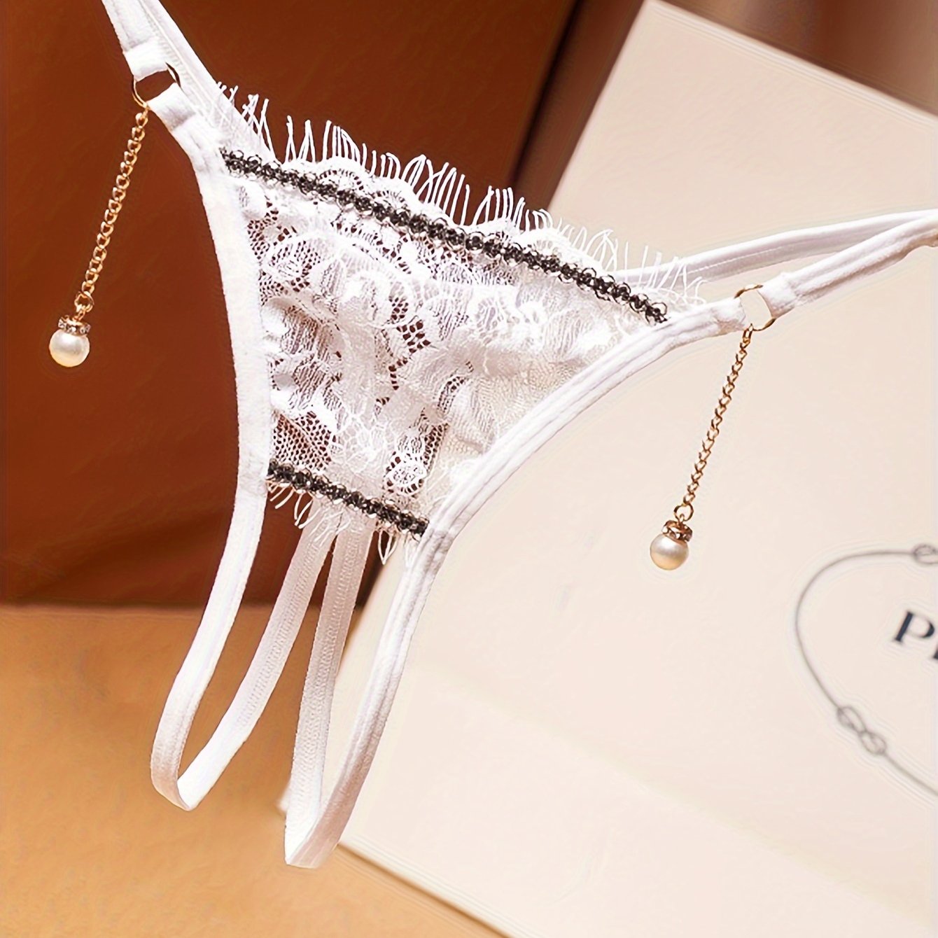 Floral lace thong with pearl pendant, open crotch design, low waist lingerie for women.