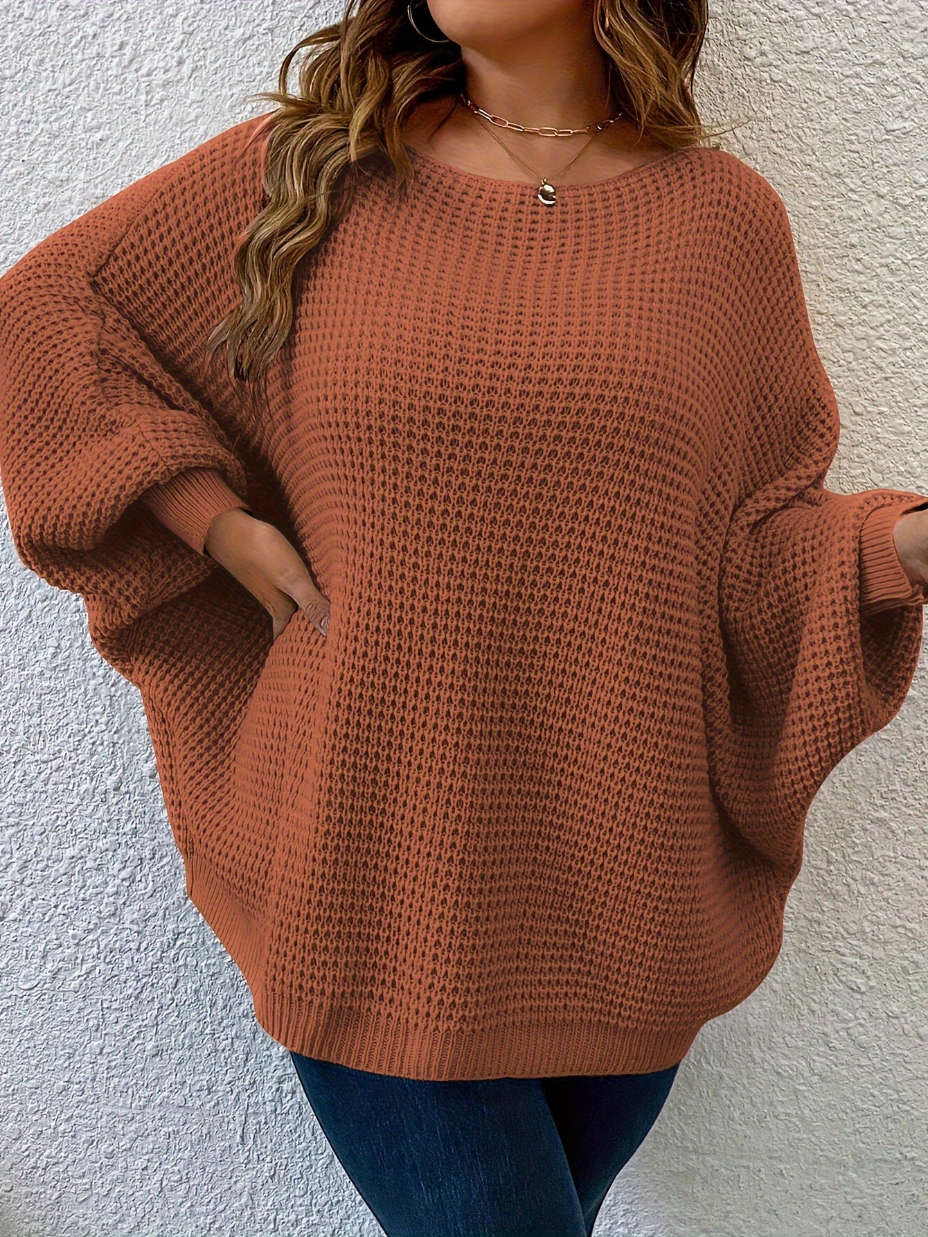 Women's plus size solid color pullover sweater with casual batwing sleeve and crew neck.