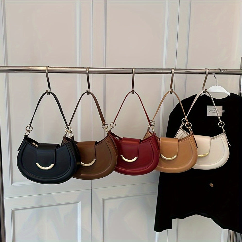 Urban crossbody bag in multiple colors with kiss lock closure and polyester lining.