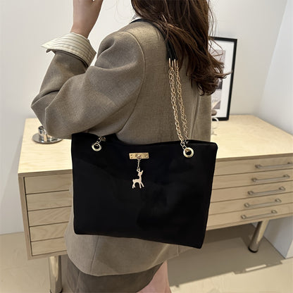 Stylish deer pendant women's tote bag with large capacity, golden-tone chain straps, black color, magnetic closure, versatile for everyday use.