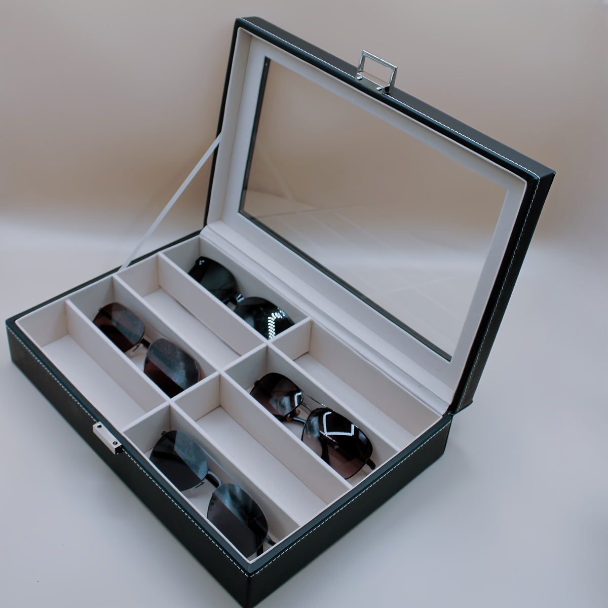 Organize your sunglasses in style with this retro PU leather eyewear display case featuring 8 slots and stitch detail. The glass lid allows you to easily see and access your sunglasses while keeping them protected. Store your glasses in this sleek and