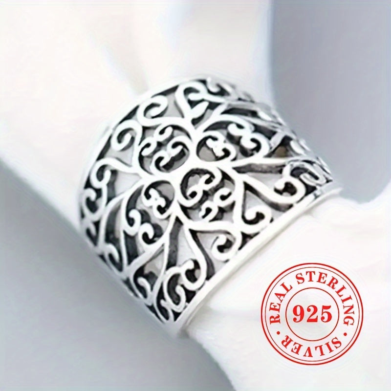 This elegant and one-of-a-kind lady's ring is crafted from high-quality S925 sterling silver, weighing 5.7 grams. It showcases a stunning hollowed-out floral vine design on the wide face, highlighting the exquisite craftsmanship behind its creation.