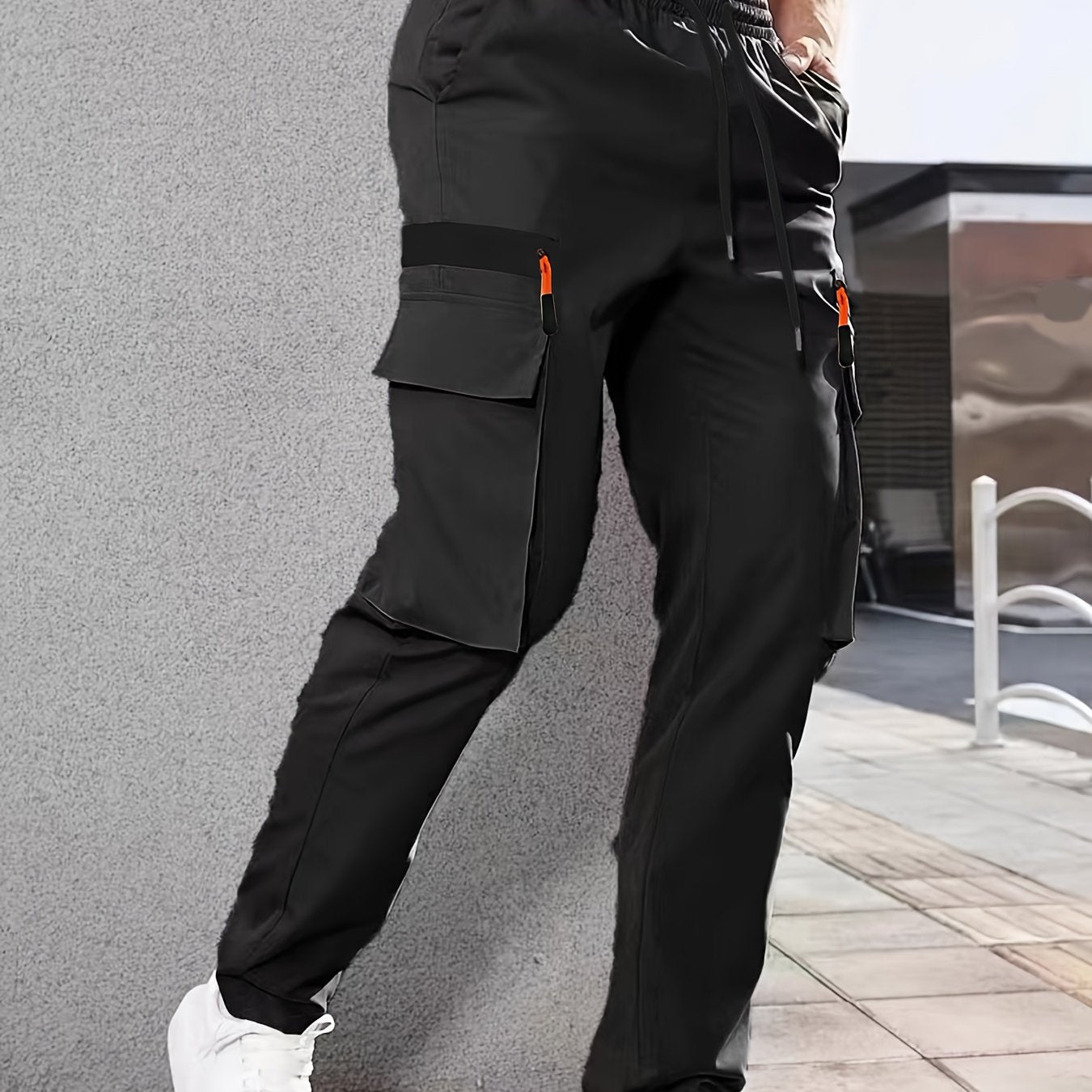 Men's casual cargo pants made of solid color polyester, feature a regular fit, multiple pockets, and straight-leg design for sports and leisure activities all year round.