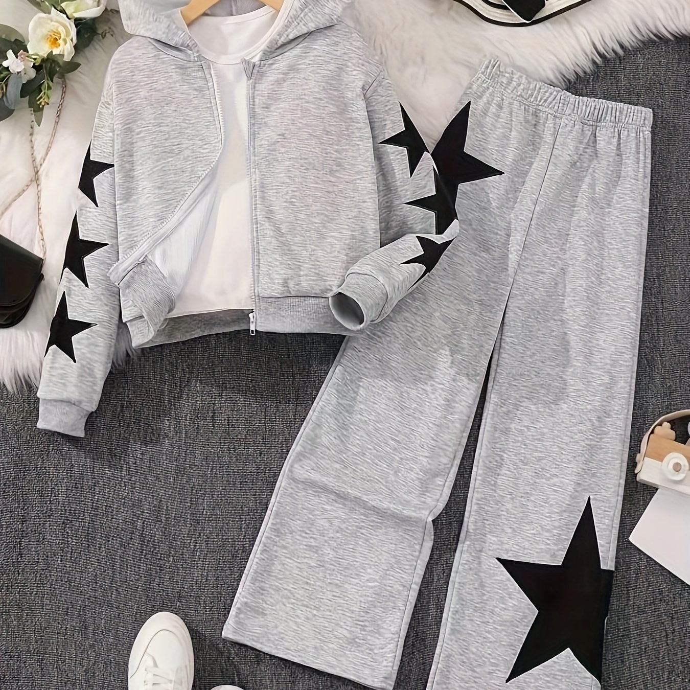 Polyester zip-up hoodie and pants set for girls with star pattern. Machine washable for easy care. Ideal for casual fall/winter outfits and outdoor activities.