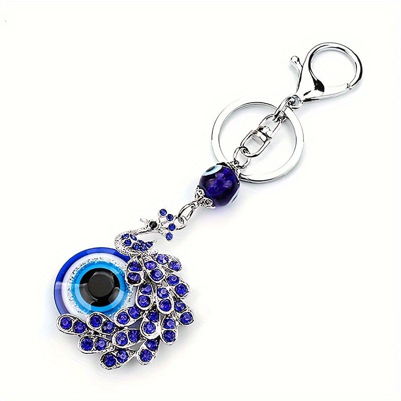 Blue Evil Eye Keychain with Rhinestone Inlaid Peacock Design, made from Alloy, Perfect for Women's Daily Use as a Trendy Hanging Pendant or Bag Charm.