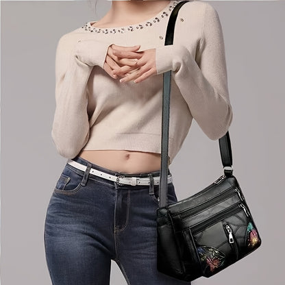 Stylish unisex crossbody bag with floral details, multiple pockets, and adjustable strap.