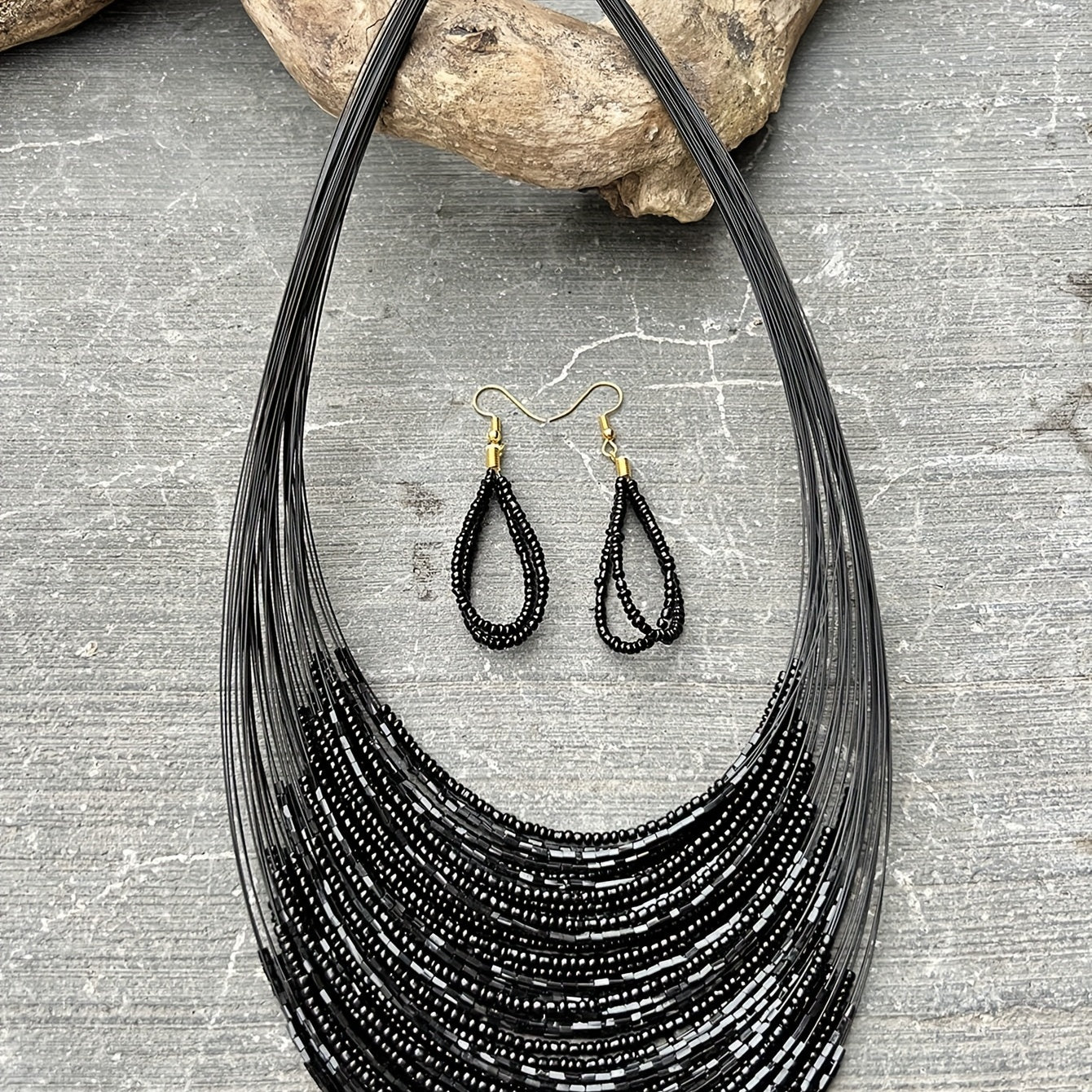 A set of three handmade earrings and a necklace crafted from elegant black beads in a multi-layer design, representing both evil and mystery. Perfect accessories to complete your daily outfits or add flair to your party attire.