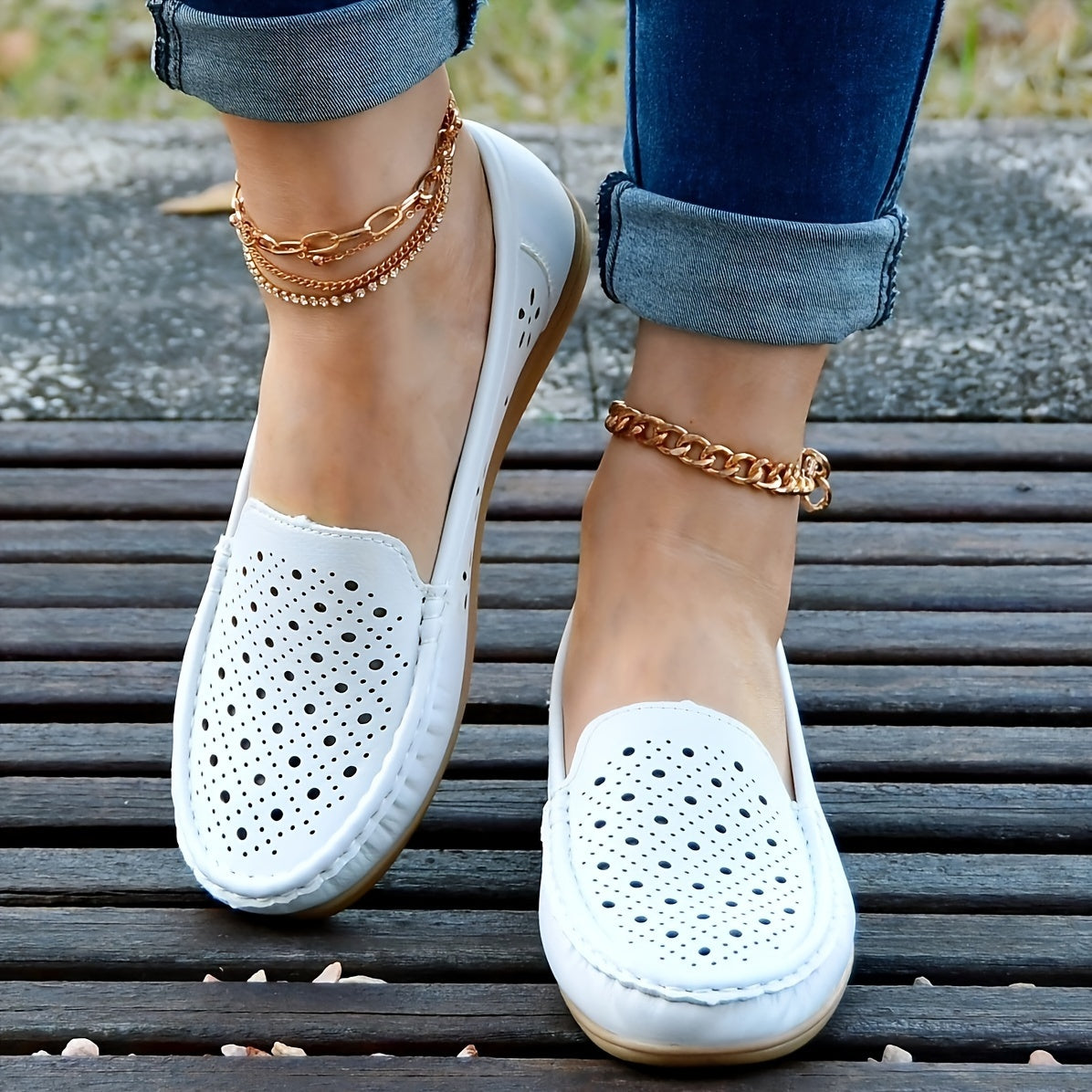 Women's white slip-on loafers with perforated design for breathability, non-slip sole, round toe, and versatile casual style for all-season wear.