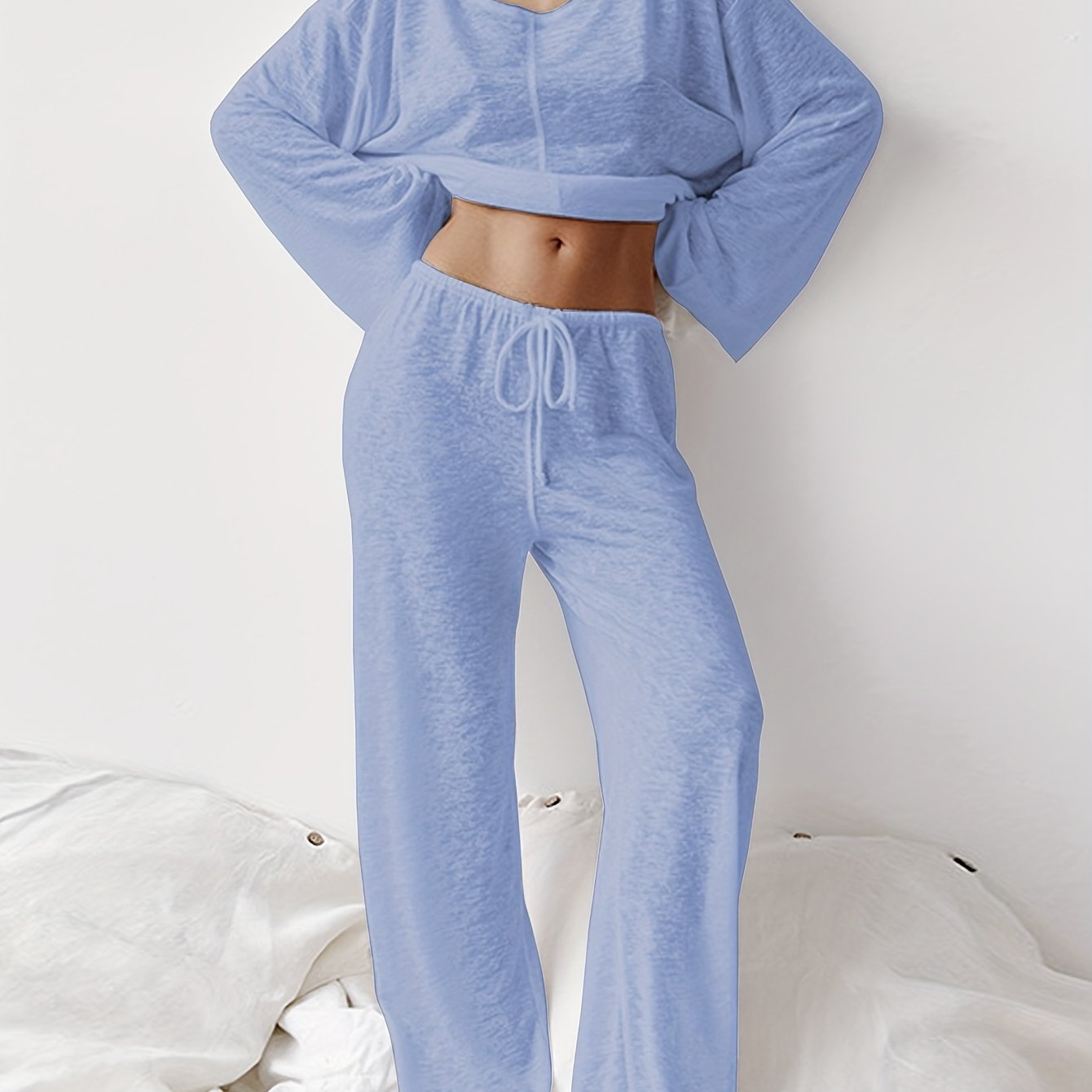 Women's two-piece set of loose and comfortable home clothes made with micro-permeable fabric, featuring round neck and long sleeves.