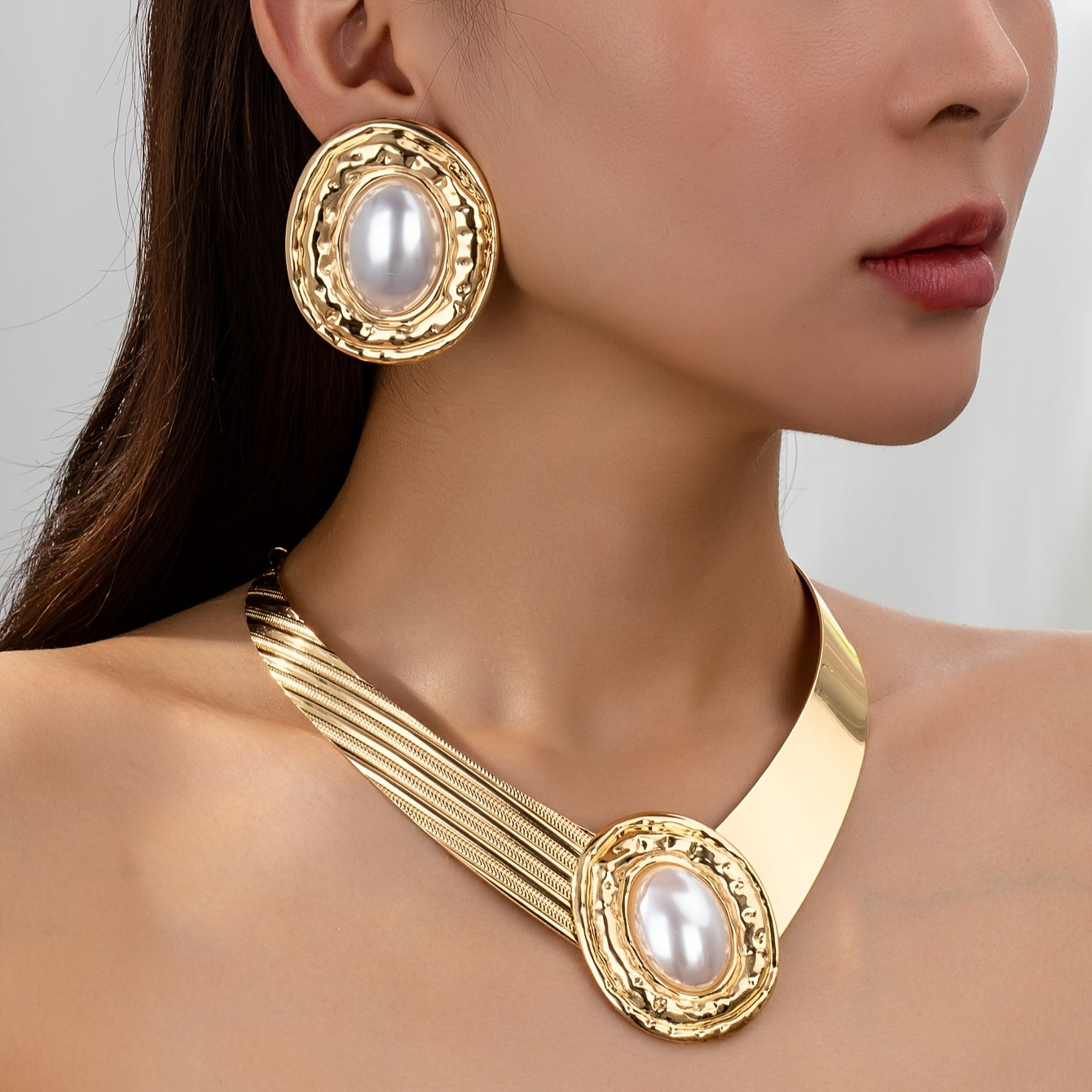 A stylish and modern set of golden pearl earrings and necklace for women, a stunning jewelry set that makes a statement - ideal for giving as a gift on special occasions.