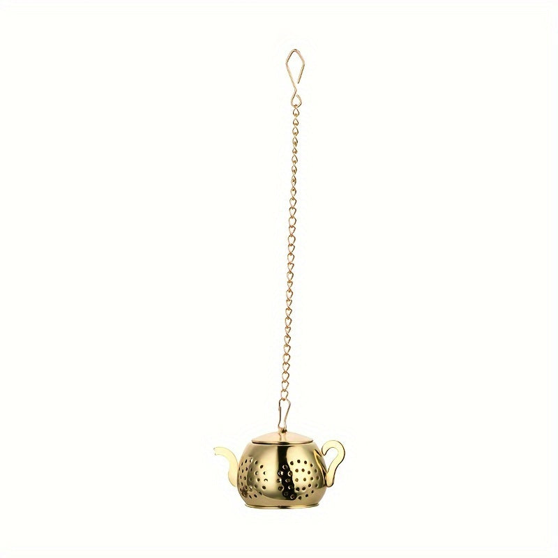 Golden rose stainless steel teapot-shaped tea strainer with uniform filter holes and hanging chain for cups.