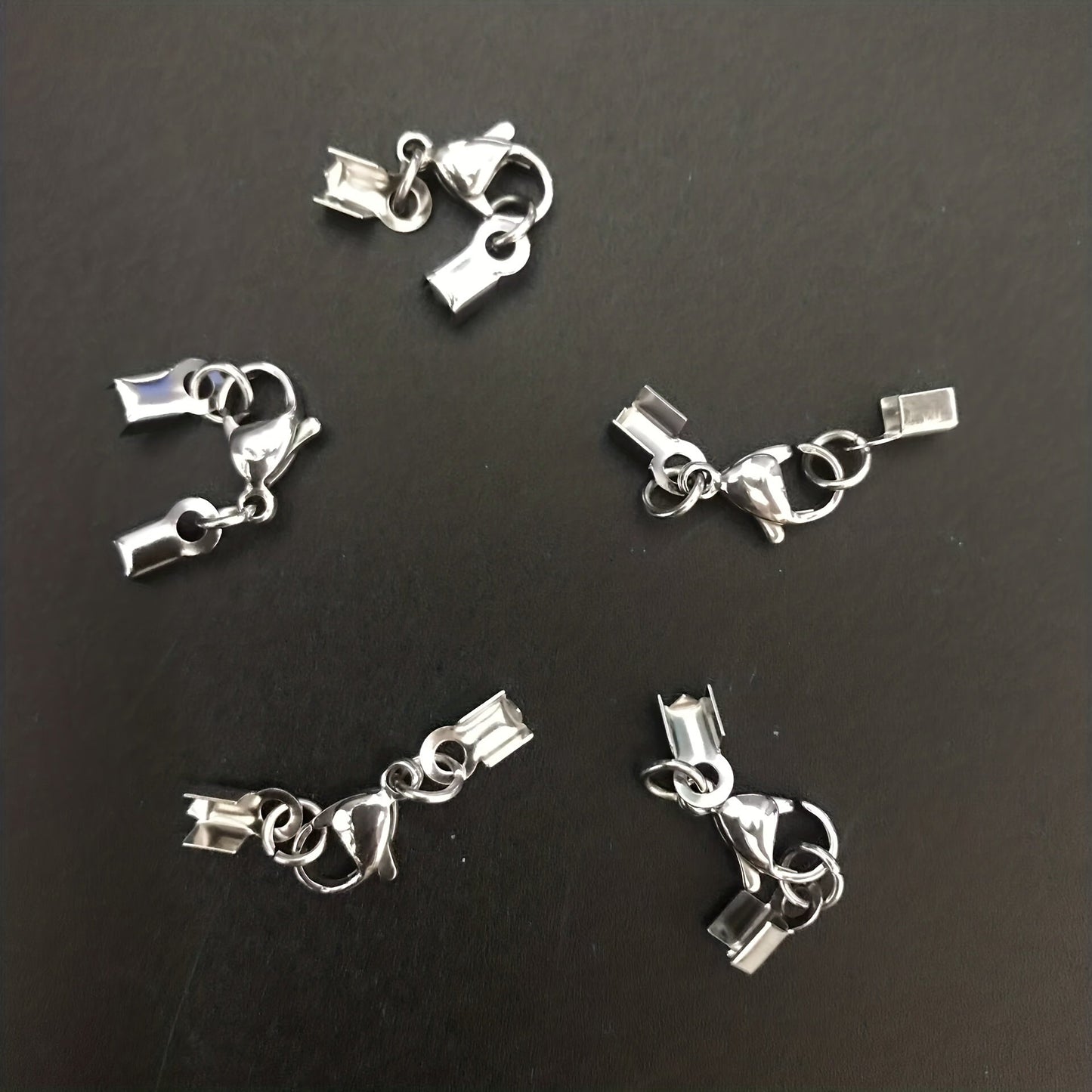 Set of 20 stainless steel rope buckle clip lobster clasps for combination necklaces, featuring a sleek design and durable stainless steel material. Ideal for jewelry crafting and accessorizing.