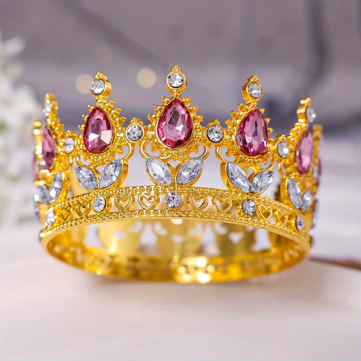 This stunning Baroque style bridal tiara features intricate golden water diamond embellishments, making it ideal for beauty pageants, proms, and formal events. Adorned with delicate flowers in a beautiful full circle design, this tiara is perfect for