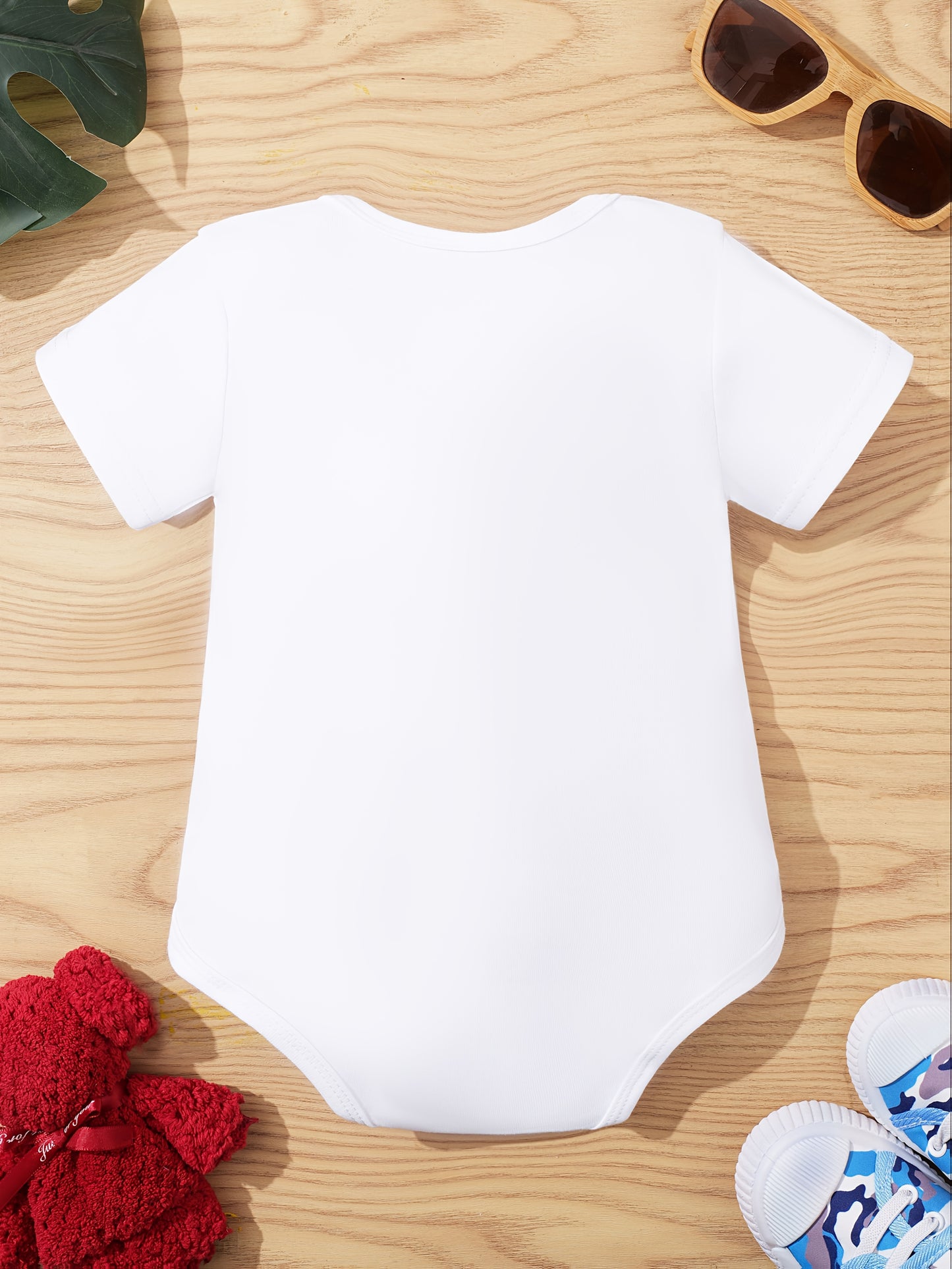 Unisex baby onesie in cotton knit with slight stretch, crew neck, button front, short sleeves, regular fit for summer. Features "My First Ramadan" letter print, suitable for outdoor wear.