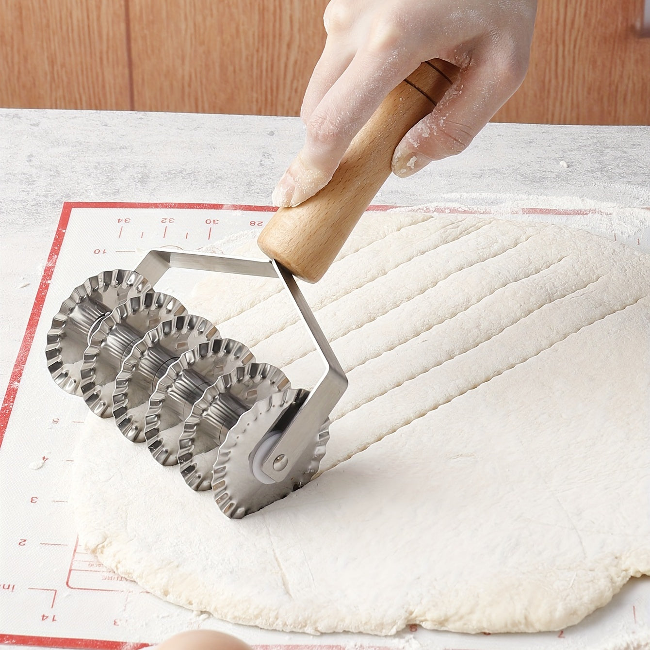 Six-wheel stainless steel cookie and noodle cutter with a wavy wood handle - Perfect for cutting cookies and noodles in the kitchen.