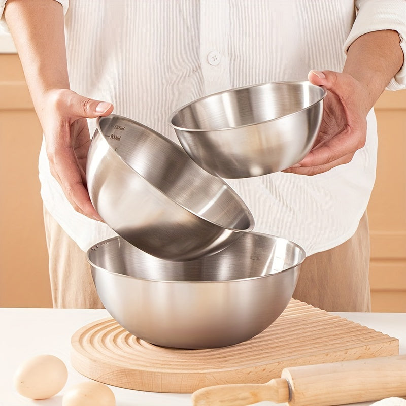 Set of 3 stainless steel mixing bowls with measurement marks, ideal for cooking and baking in kitchens and restaurants.