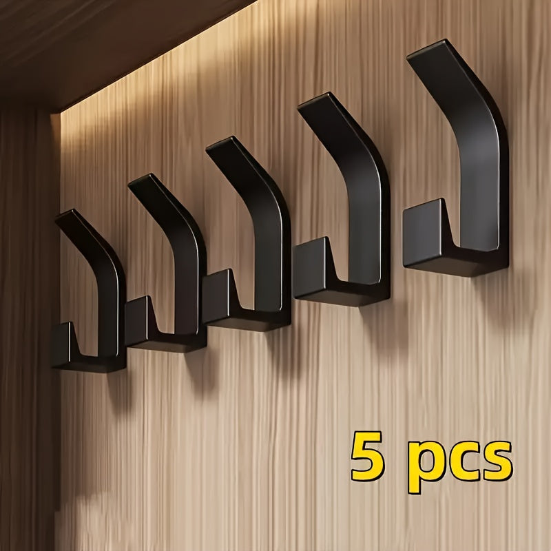 5-Pack of easy-to-install, no-drill wall hooks for towels and coats. Adhesive, space-saving design in a contemporary style. Made of plastic for wall-mounted organization in bathrooms, bedrooms, and homes.