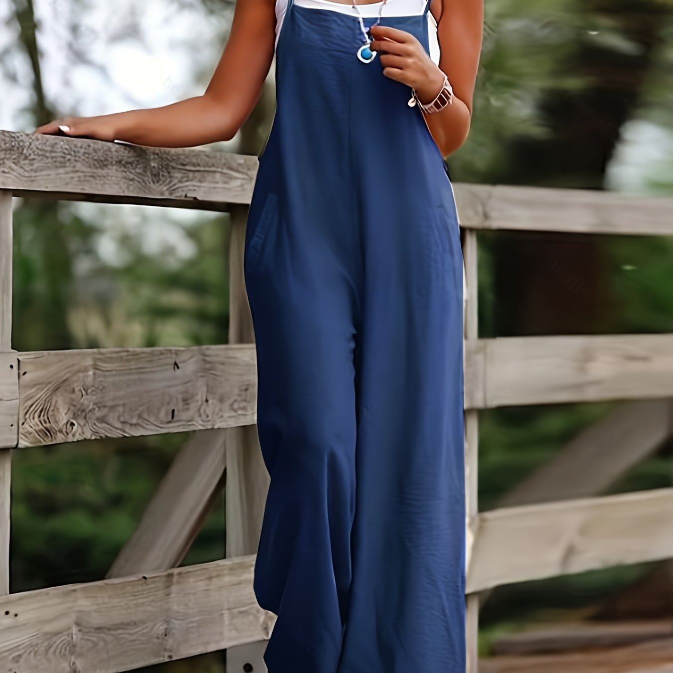 Wide leg jumpsuit with spaghetti straps, sleeveless with pockets, versatile women's clothing.