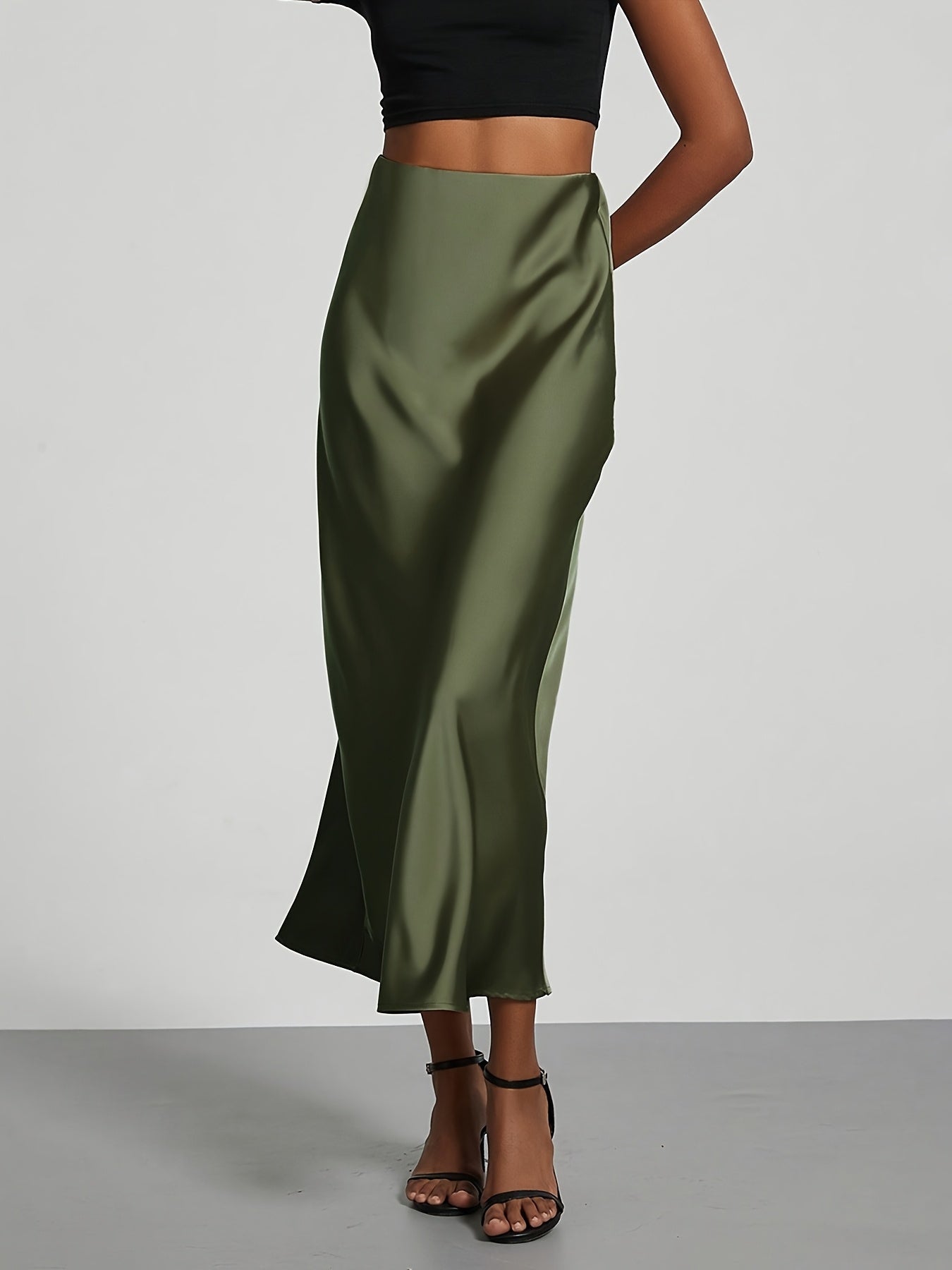 Elegant black high-waisted maxi skirt with A-line cut and smooth satin fabric, perfect for any occasion. Casual chic at its best.