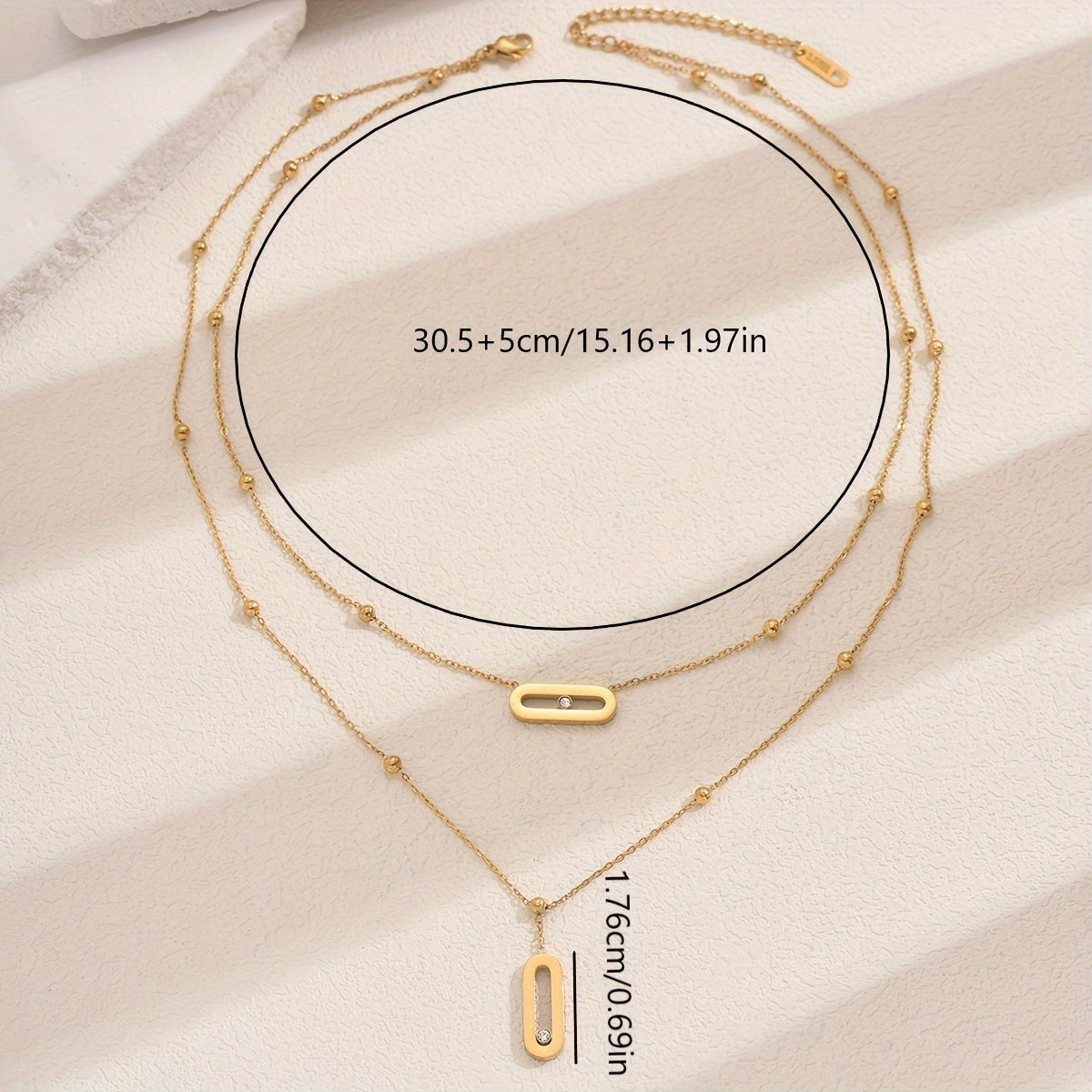 Elevate your look with this sophisticated French-inspired 18K gold plated stainless steel necklace featuring double layers and sparkling rhinestone accents. The versatile geometric pendant is perfect for women, ideal for both everyday wear and as a