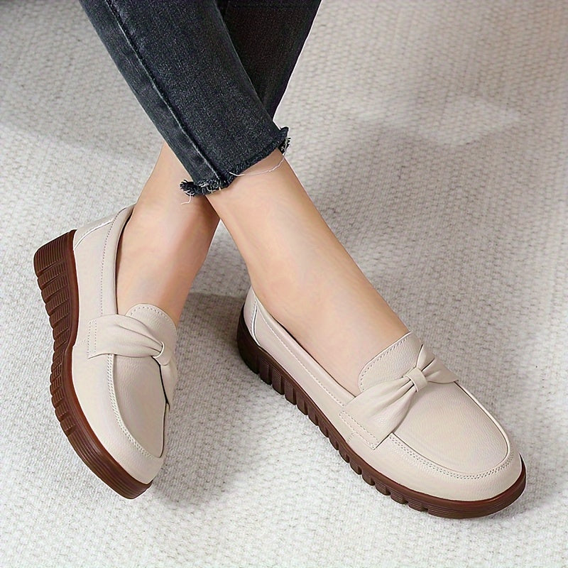 Women's comfortable penny loafers with bow embellishment, non-slip sole, round toe, all-season footwear, man-made materials, TPR sole.