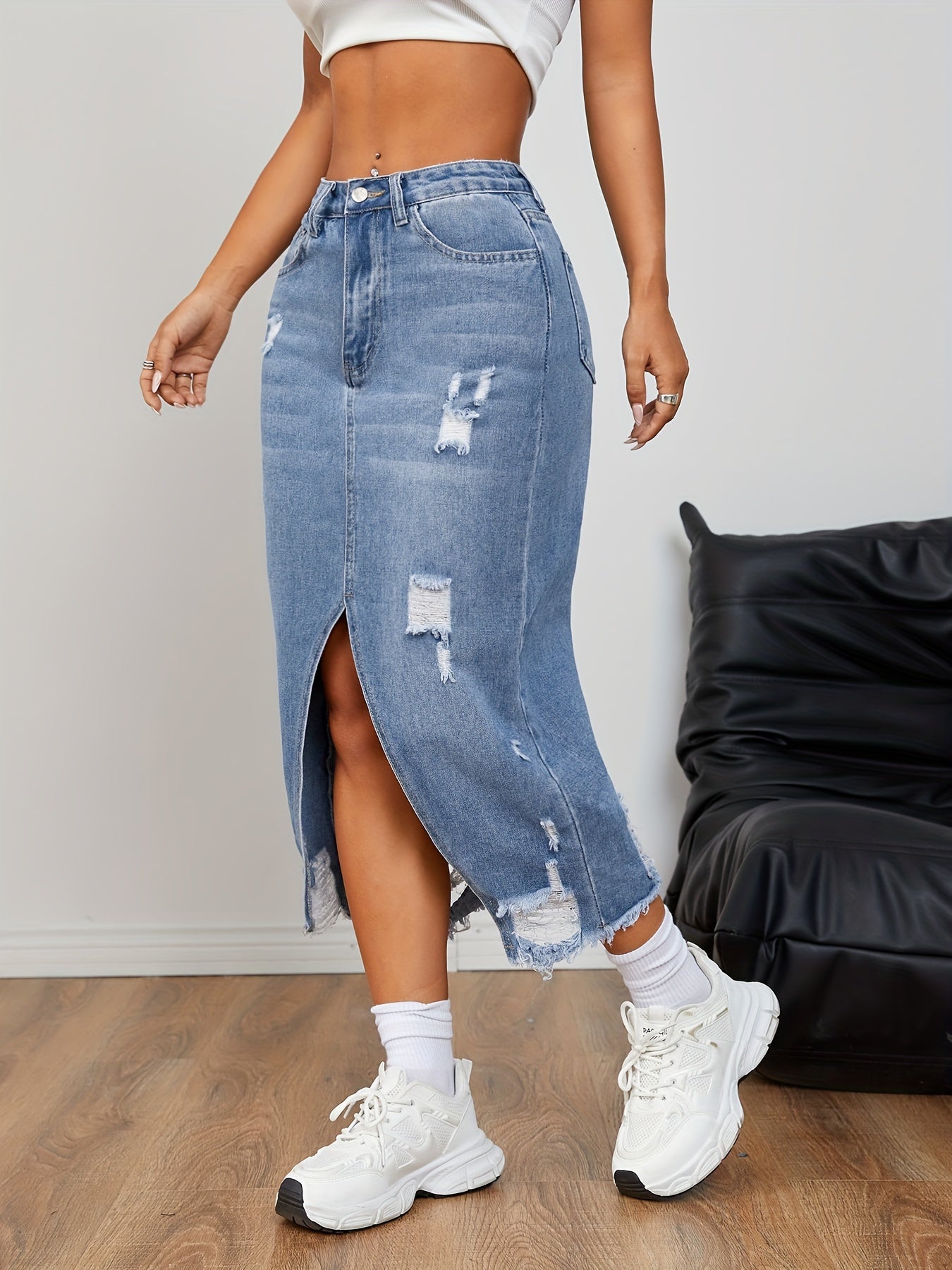 Casual distressed denim skirt with raw hem and slit for women.