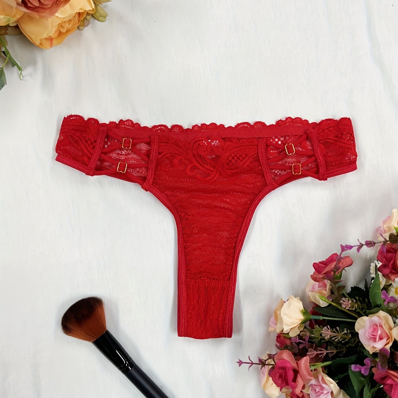 Red lace thong panties for women with floral pattern and scalloped trim. Made of breathable polyester blend that is semi-sheer and hand washable.