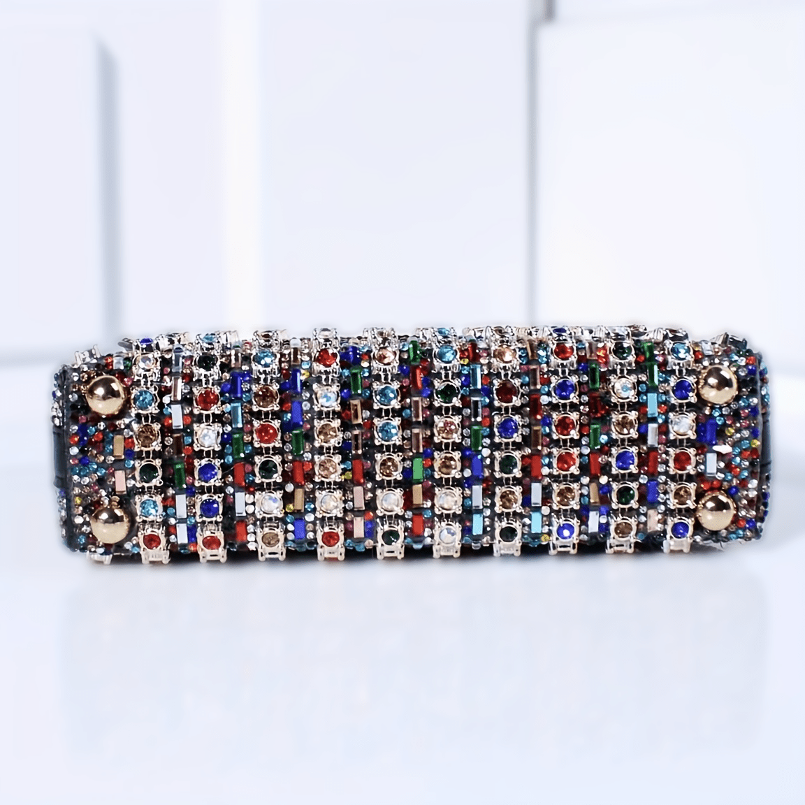 Stylish women's evening clutch with rhinestones and beads, adjustable strap, and magnetic closure, perfect for formal events.