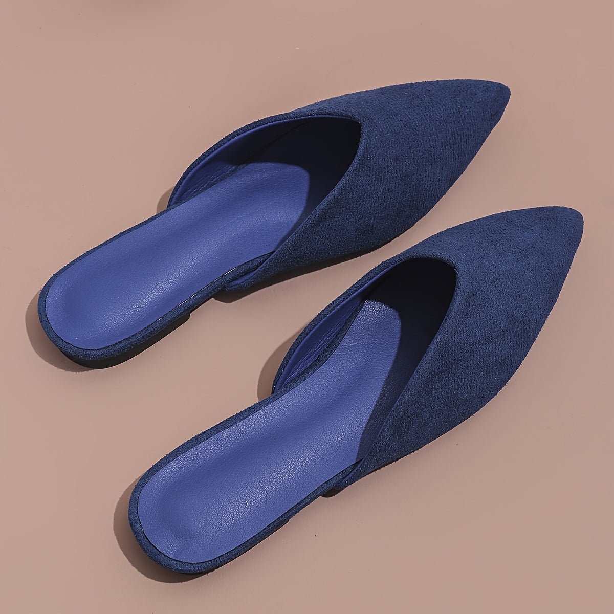 Stylish orange flat mules for women in plus sizes with pointed toe and slip-on design, perfect for casual wear.