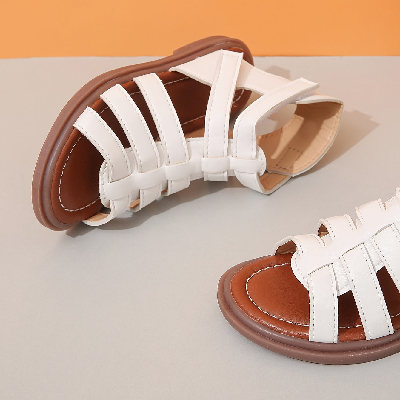 Ivory sandals for girls with brown sole, ideal for school and leisure activities.