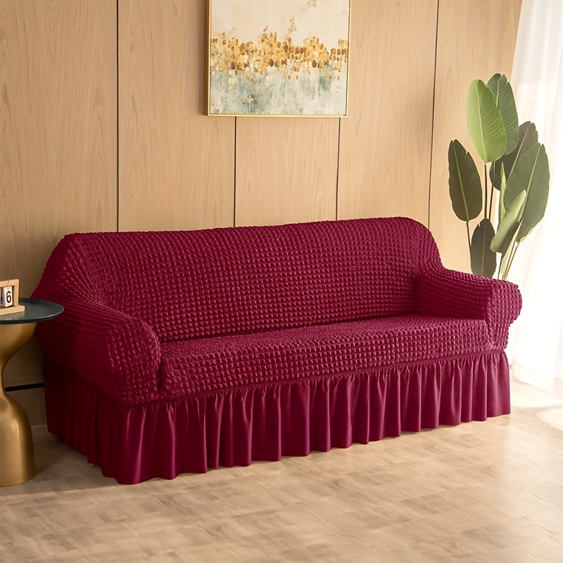 Non-slip elastic sofa cover with skirt for home decor.